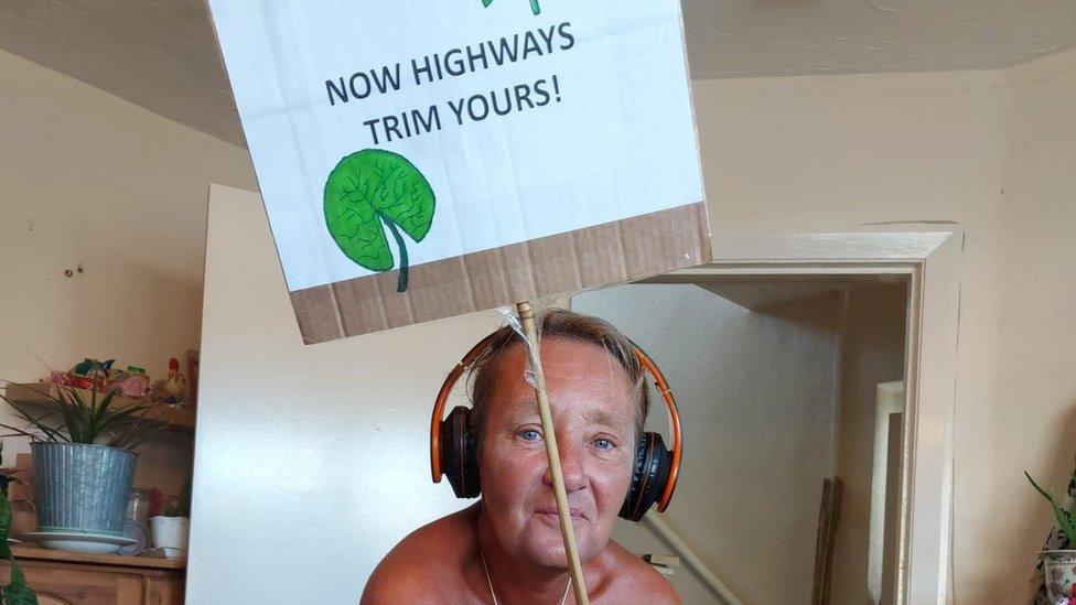 Jill White holding sign