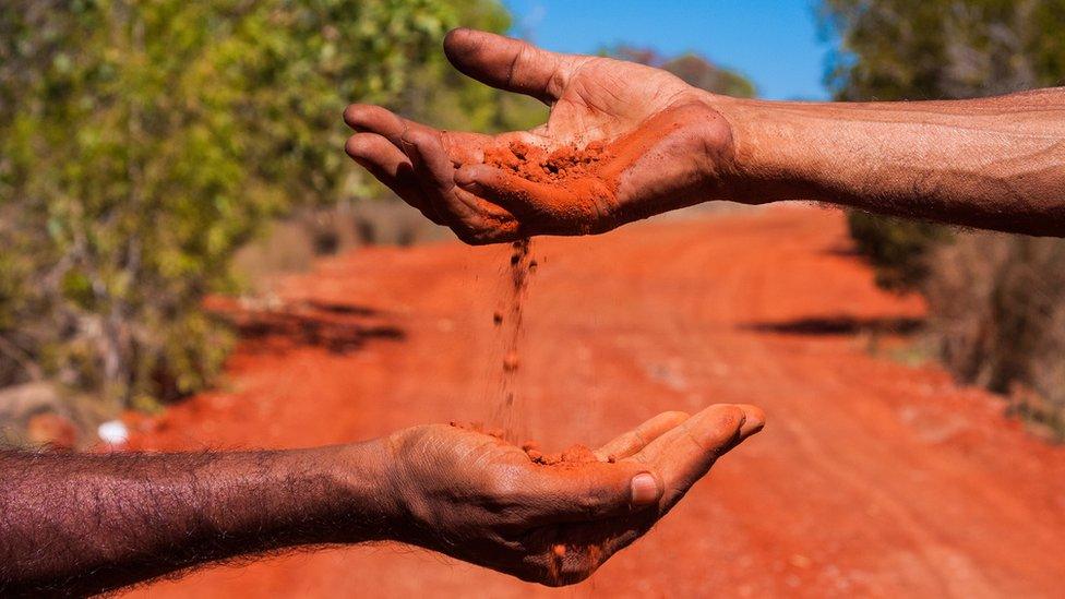 Dirt passes between hands