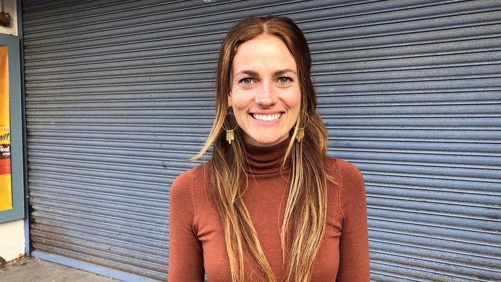 Yoga teacher Kellie Walker in front of shop shutters