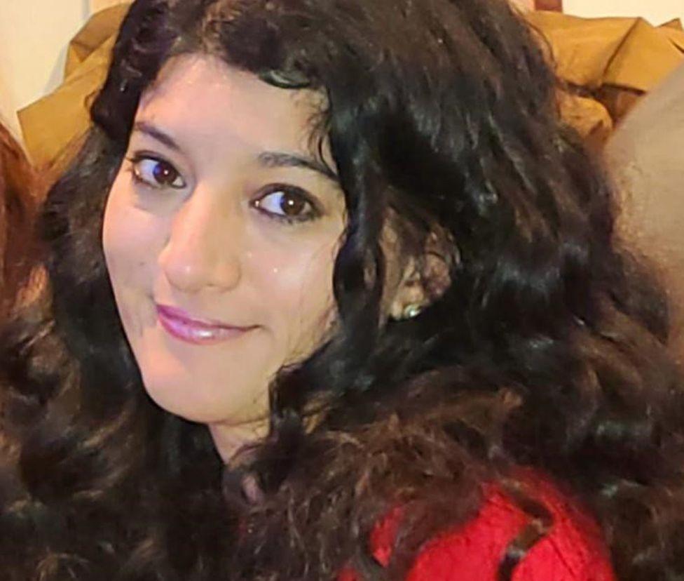 Image showing Zara with dark curly hair and wearing a red jumper