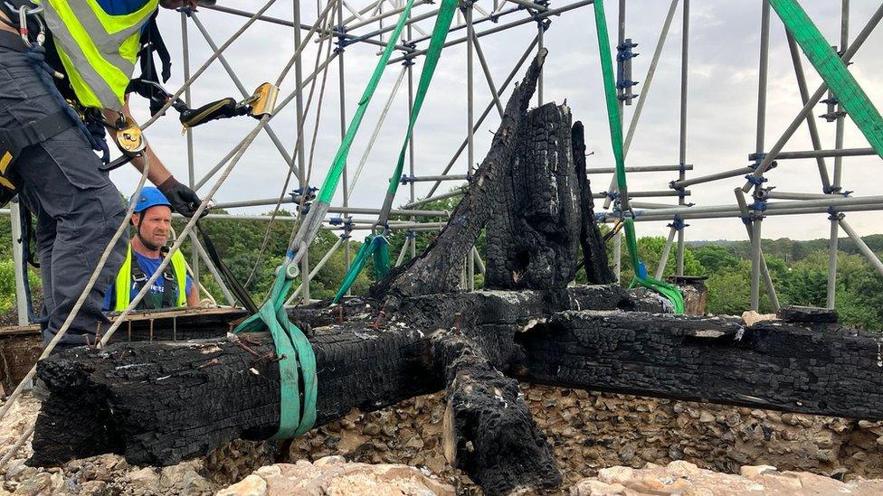 Abseilers remove the blackened bell frame