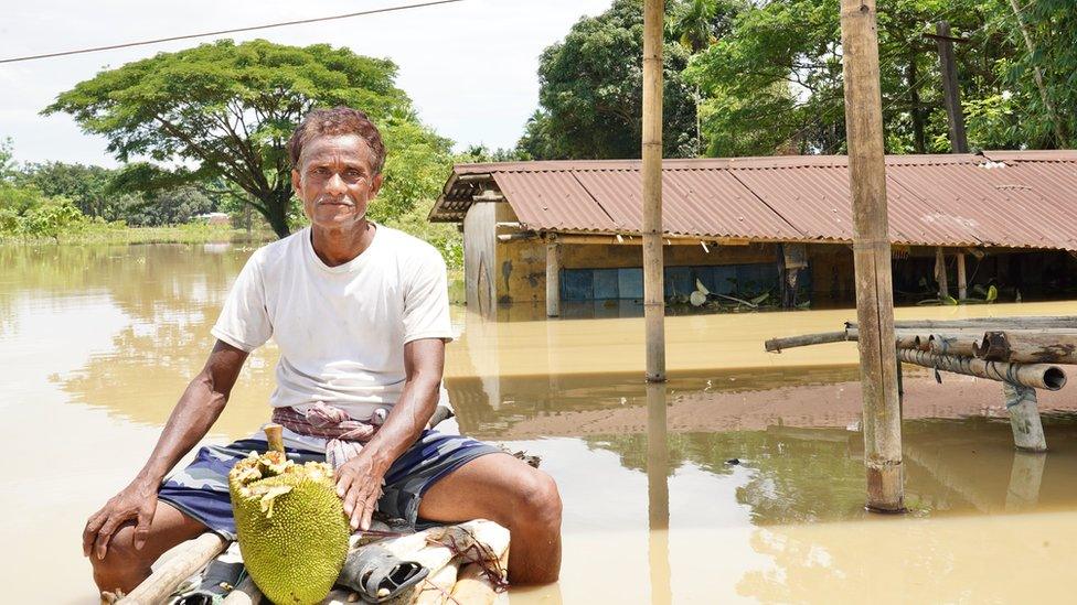 Man seen outside makeshift shelter in Assam