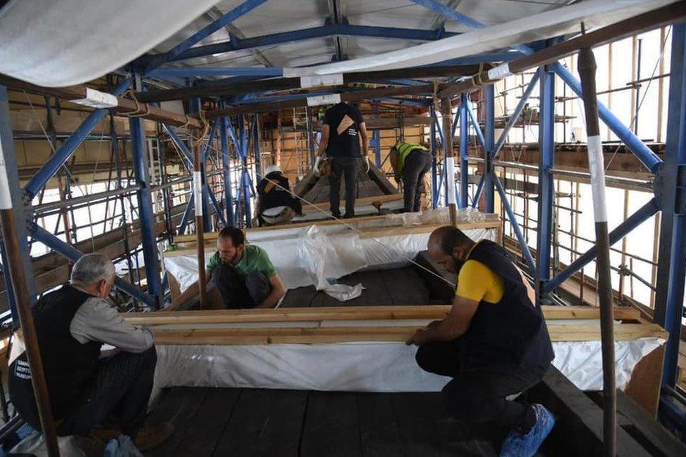 Experts work inside the Great Boat of King Khufu