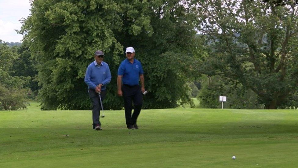 Graham Sutherland and Mark Phillips playing golf