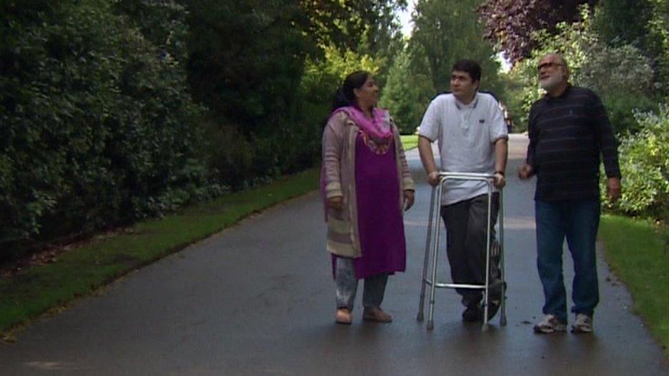 Muhammad Ibrahim Khan, alongside his parents, walking with the help of a walking frame