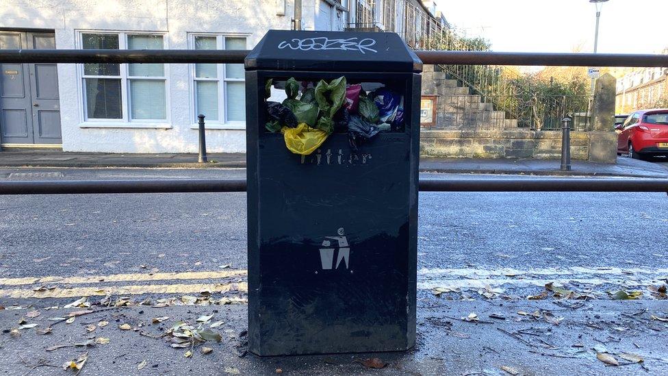 Bin filled with poo bags