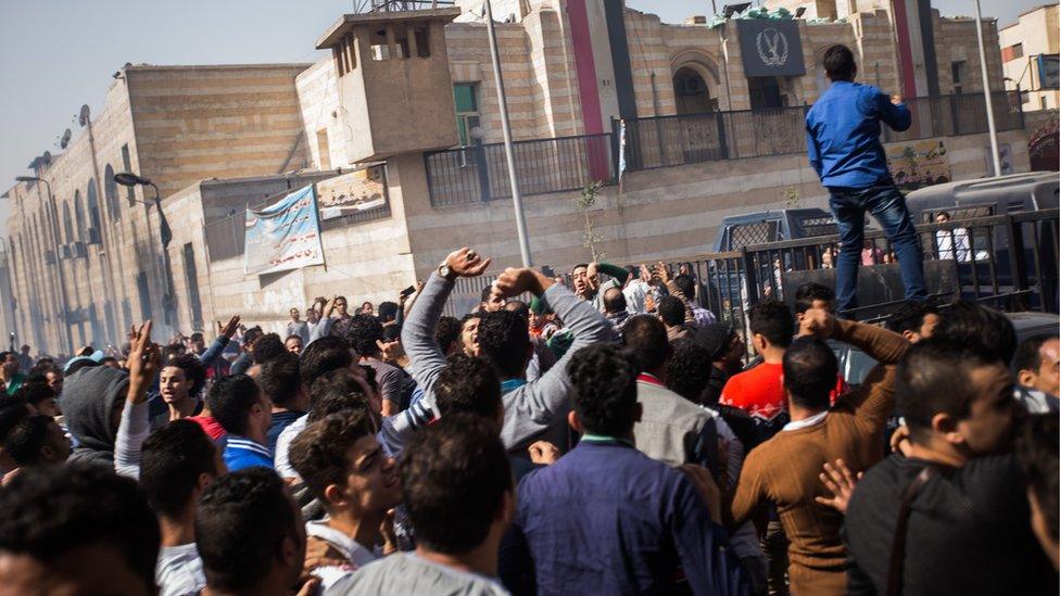 Mourners protest the death of Mohamed Ali, a 23 year-old driver, who was shot dead overnight during a dispute with a police sergeant, outside local security headquarters in Cairo, Egypt, Friday, Feb. 19, 2016.