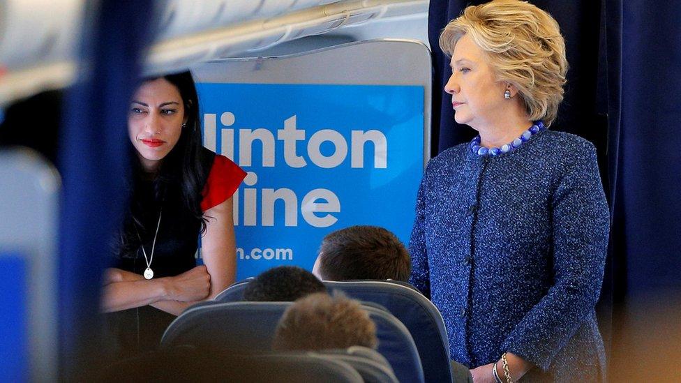 U.S. Democratic presidential nominee Hillary Clinton talks to staff members, including aide Huma Abedin (L), onboard her campaign plane in White Plains, New York, U.S. October 28, 2016