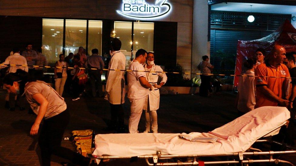 Employees are seen after a fire hit the Badim Hospital in Rio de Janeiro, Brazil September 12, 2019