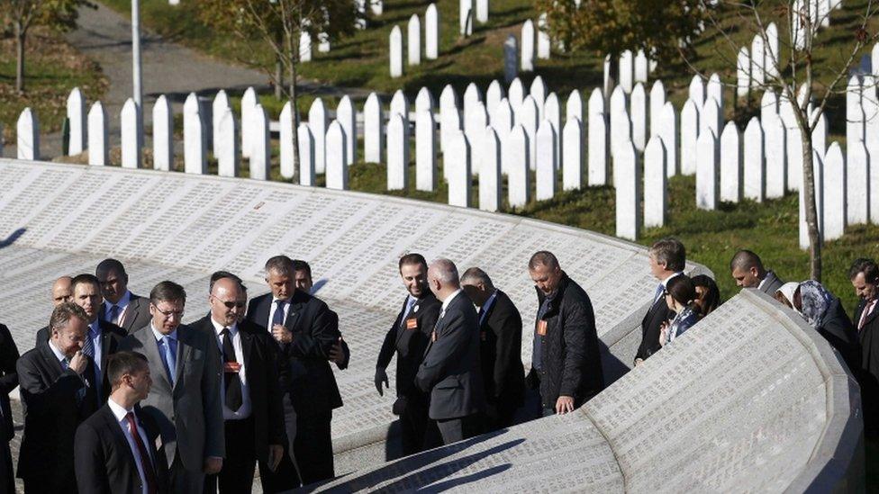 Serbia's Prime Minister Aleksandar Vucic (fourth left) is accompanied by Bakir Izetbegovic (left), member of Tripartite Bosnian Presidency, as they walk at the Memorial Center Potocari, near Srebrenica, Bosnia and Herzegovina, 11 November 2015