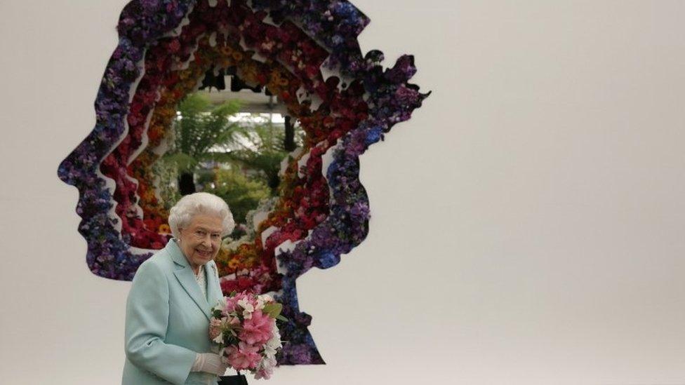 The Queen with a giant portrait created using flowers