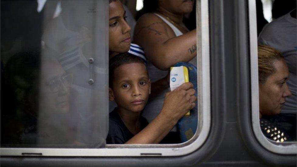 Relatives and friends of Eduardo Felipe Santos Victor, a teenager who was killed at Morro da Providencia favela, ride a bus to his burial service, in Rio de Janeiro, Brazil, Wednesday, on 30 September 2015.