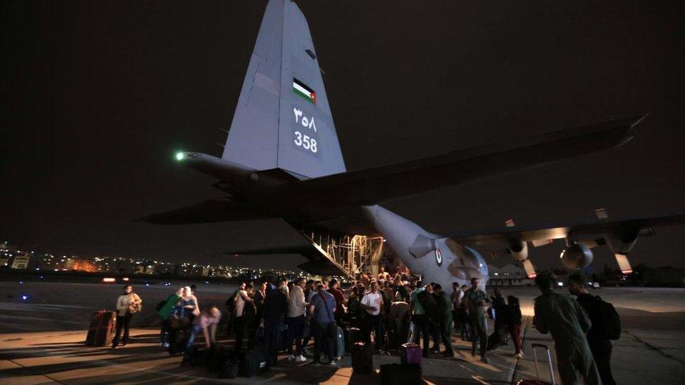 People from a group of 343 citizens of Jordan, Palestine, Iraq, Syria, and Germany who were evacuated from Sudan disembark from military aircraft at Marka Military Airport, in Amman, Jordan, 24 April 2023.