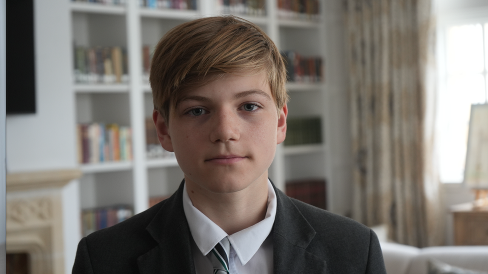 School pupil Luke sitting in school library