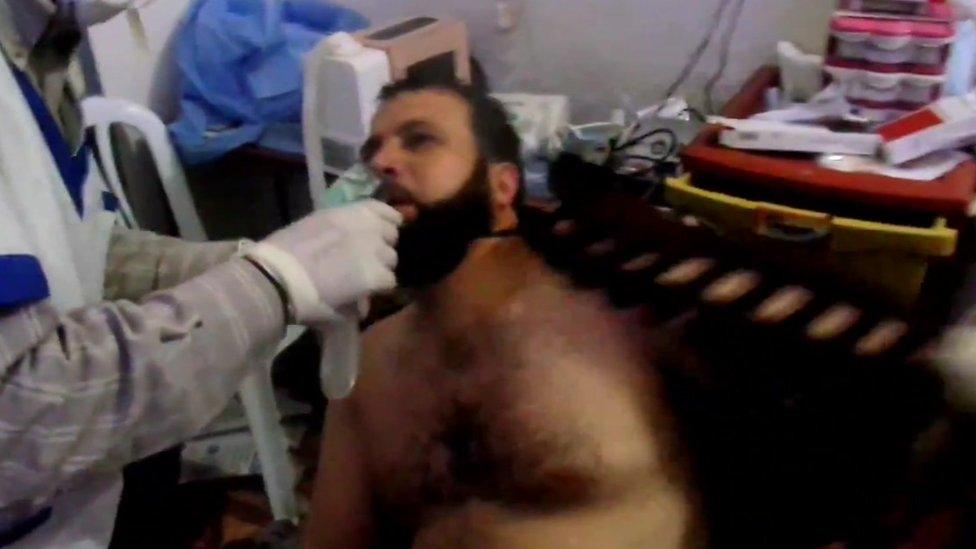 A Syrian man is treated in the aftermath of an alleged chemical weapons attack