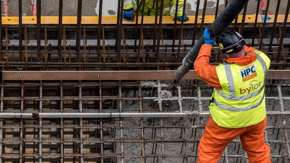 Worker pouring concrete at Hinkley C