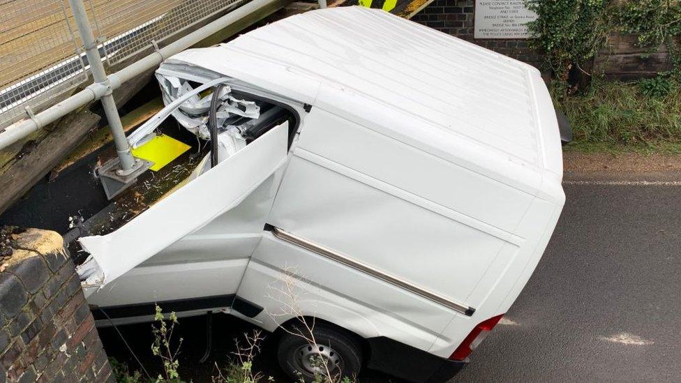 Van under railway bridge