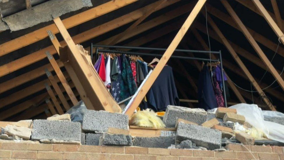 Exposed roof of a house showing clothes in a room