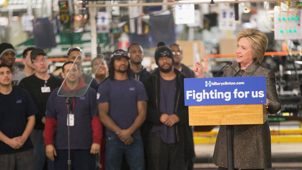 Clinton speaks on the floor of a Detroit manufacturing plant