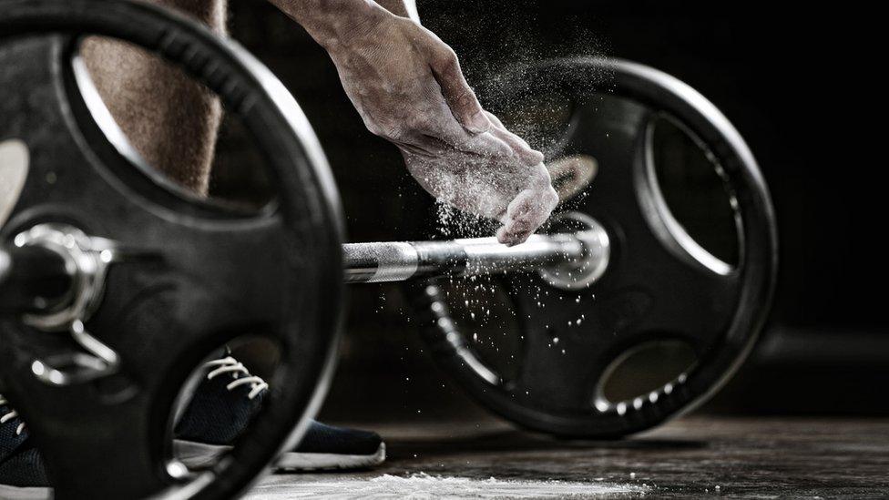 Weights being lifted in a gym