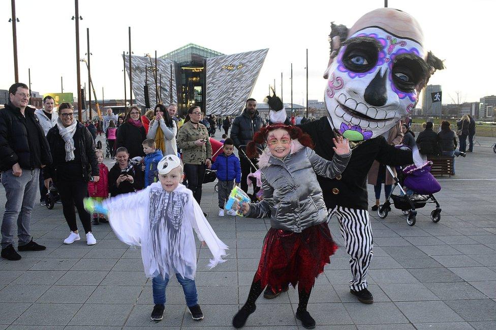 Children in costumes with a performer at the Halloween Monster Mash in Belfast