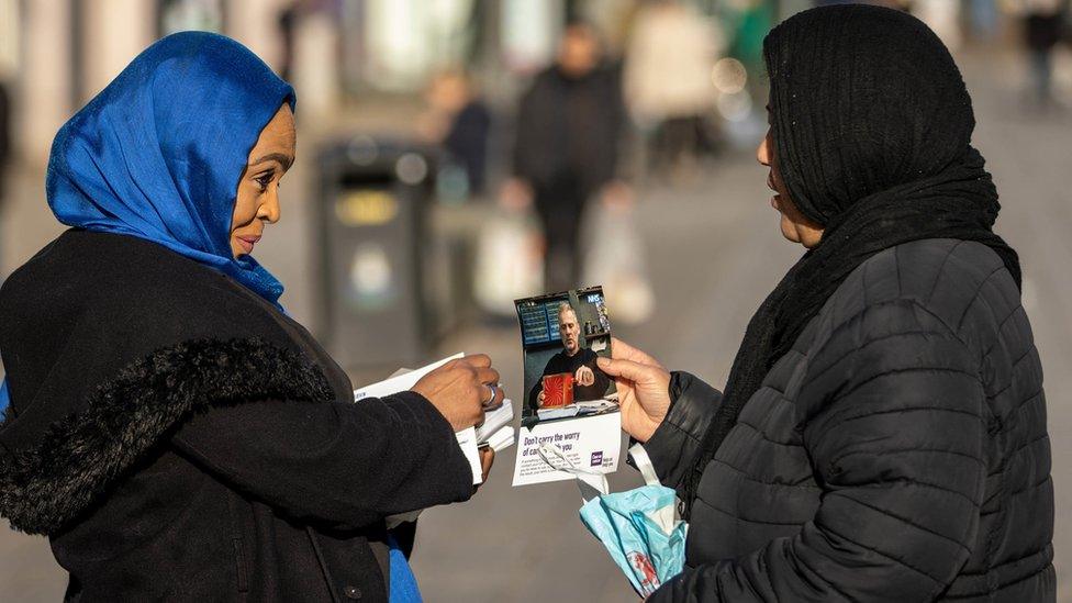 Cancer tour handing out leaflets