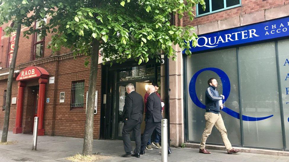 people walking outside the Electoral Office in Belfast