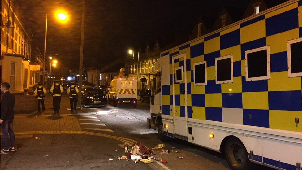 Police patrol the streets on Monday night in the Holyland area of Belfast