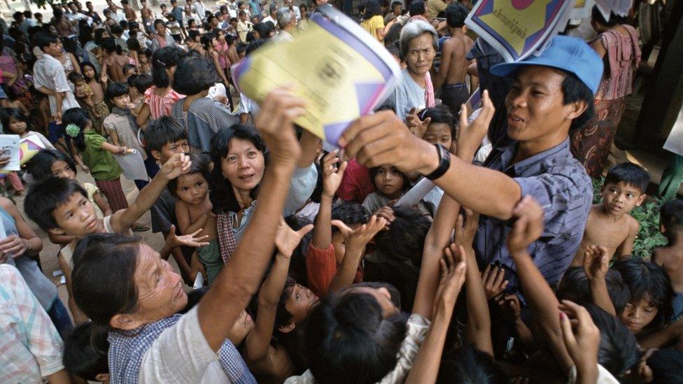 An official from Untac (the United Nations Transitional Authority in Cambodia) hands out election information posters in a small village close to the capital.