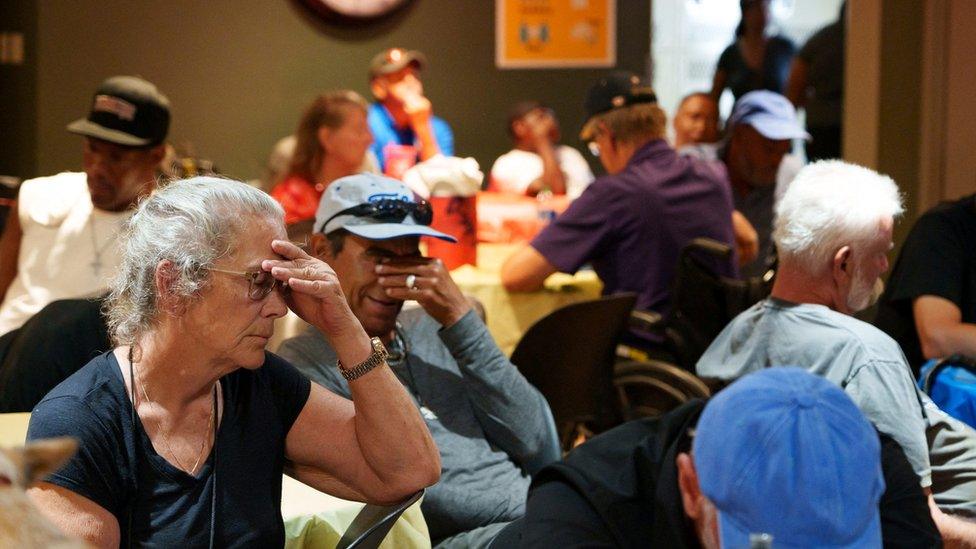 People sit inside a Phoenix cooling centre