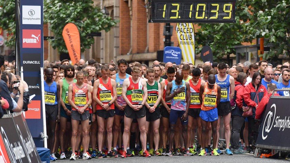 Runners hold a minute's silence