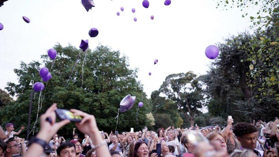 People release balloons at a vigil for Archie Battersbee