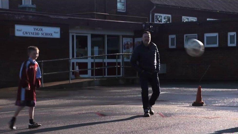 Ian Puleston-Davies watching a football game at his old school