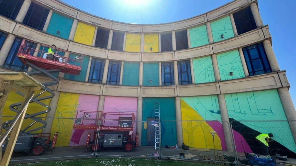 Artists painting a wall