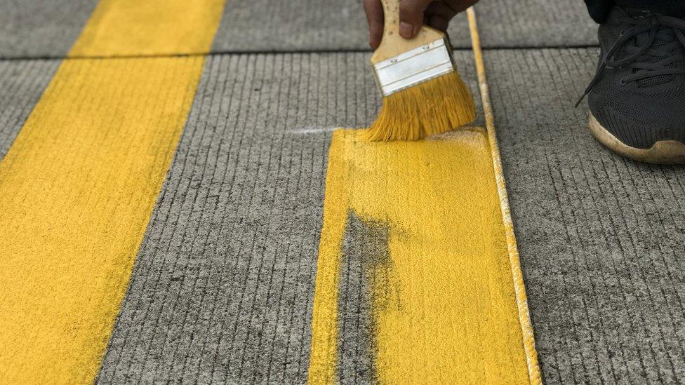 Man painting parking lines