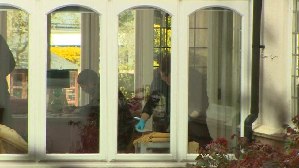 Police search author's home