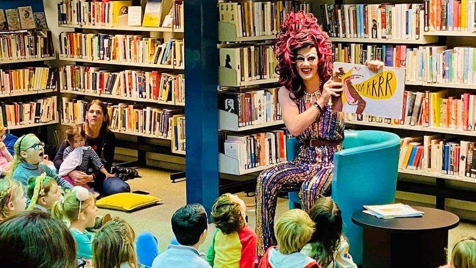 Aida H Dee reading a story to children