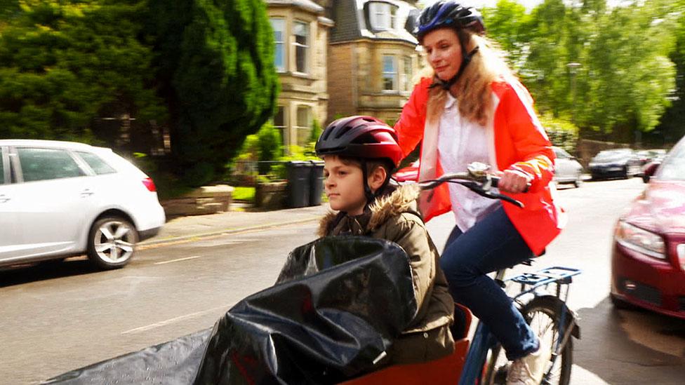 Michaela Jackson and her 10-year-old son Rafael ride on an e-cargo bike