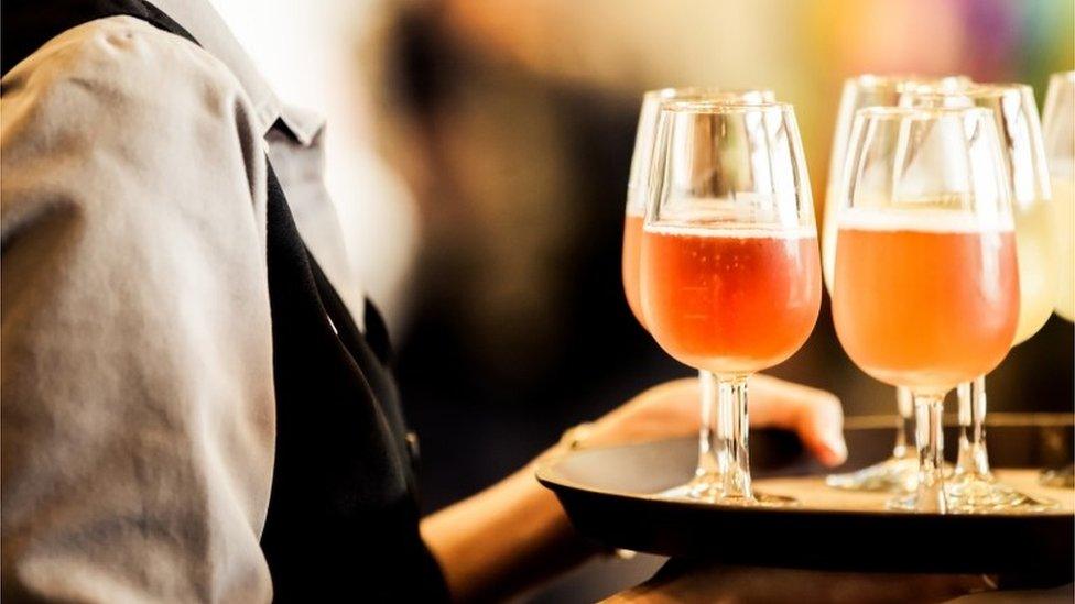 Waiter carrying tray of drinks