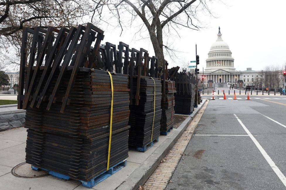 Stacks of security fencing are seen near the US Capitol in preparation for the upcoming inauguration of President-elect Donald Trump, 16 January