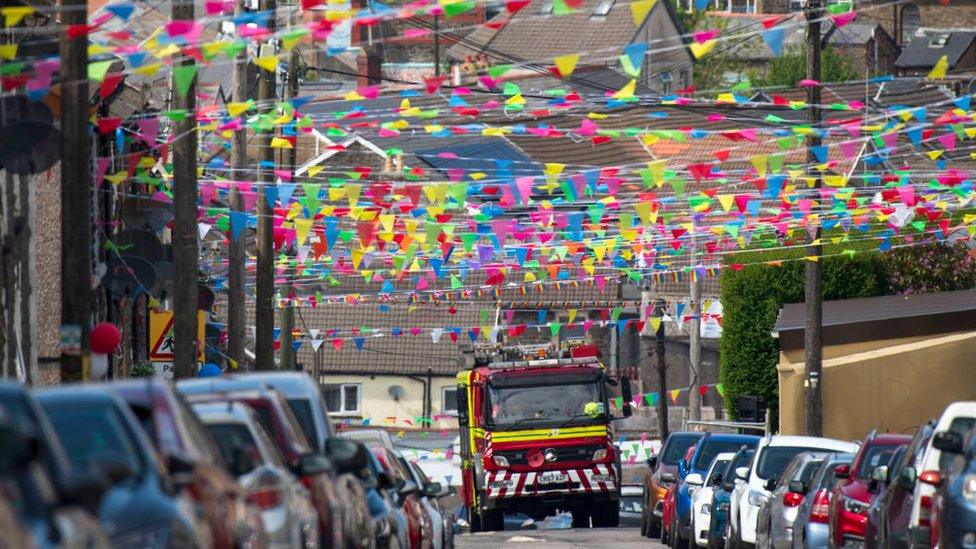 fire engine drives under bunting in Penygraig