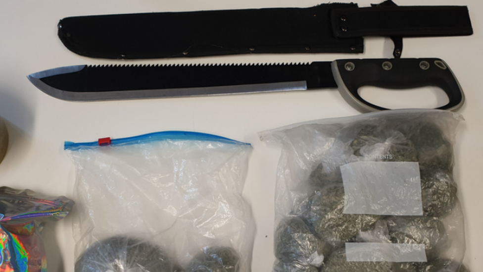 Machete and drugs on a table