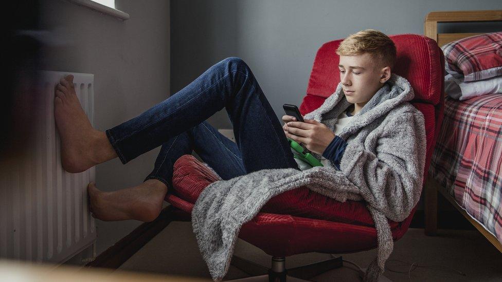 A young man holding a phone