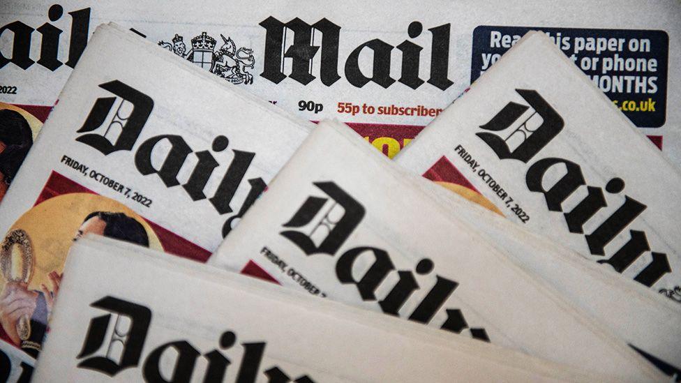 Multiple copies of the "Daily Mail" newspaper are laid out in a slightly overlapping arrangement. Each front page displays the date "Friday, October 7, 2022." The image emphasizes the branding and layout of the newspaper editions.