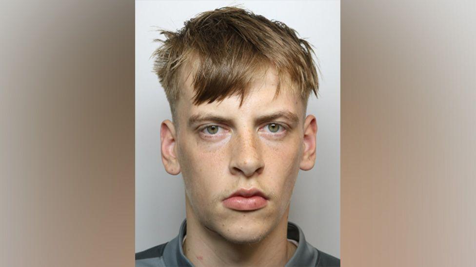 Mugshot of Bradley Mills, who has spiky, short, mousey hair