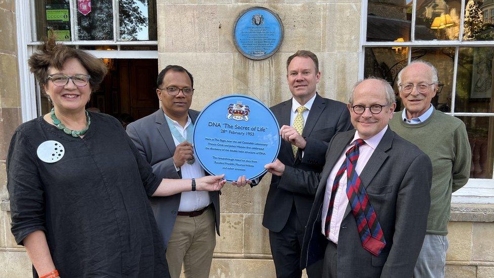 The new plaque being held by officials