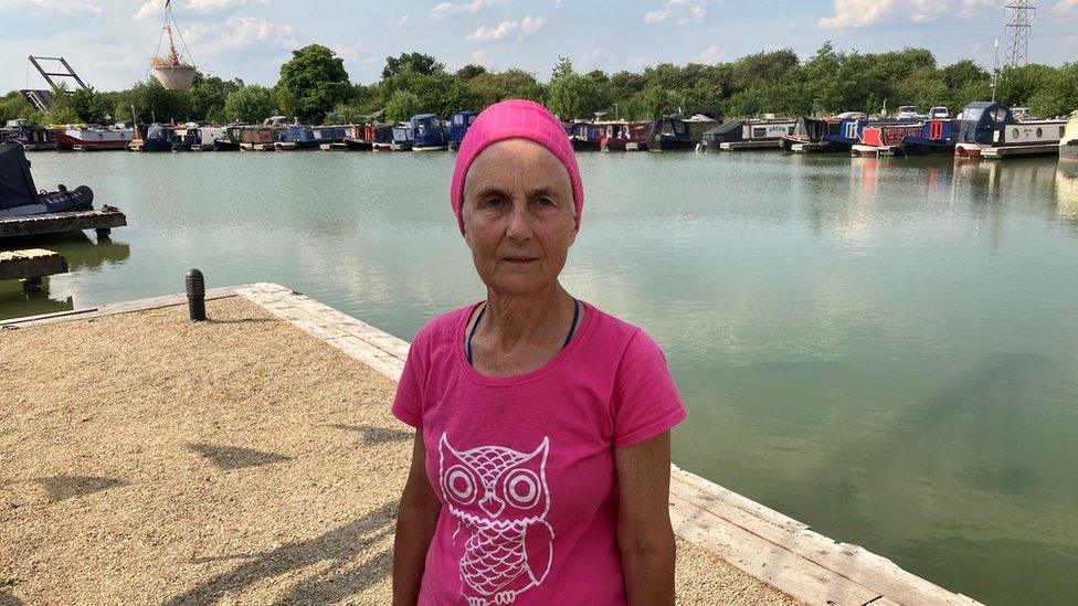 Pamela Smith, Chair of the National Barge Travellers Association standing with the Caen Hill Marina behind her