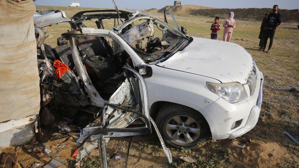 A photo of a a heavily damaged vehicle belonging to the World Central Kitchen (WCK)