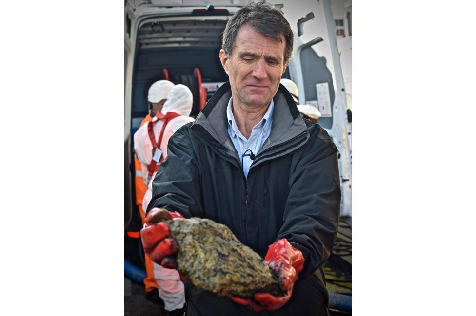 David Shukman holding a piece of a fatberg