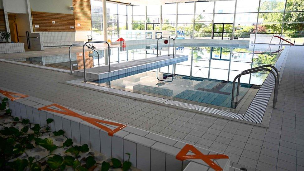 A swimming pool with tape to stop people sitting at the side